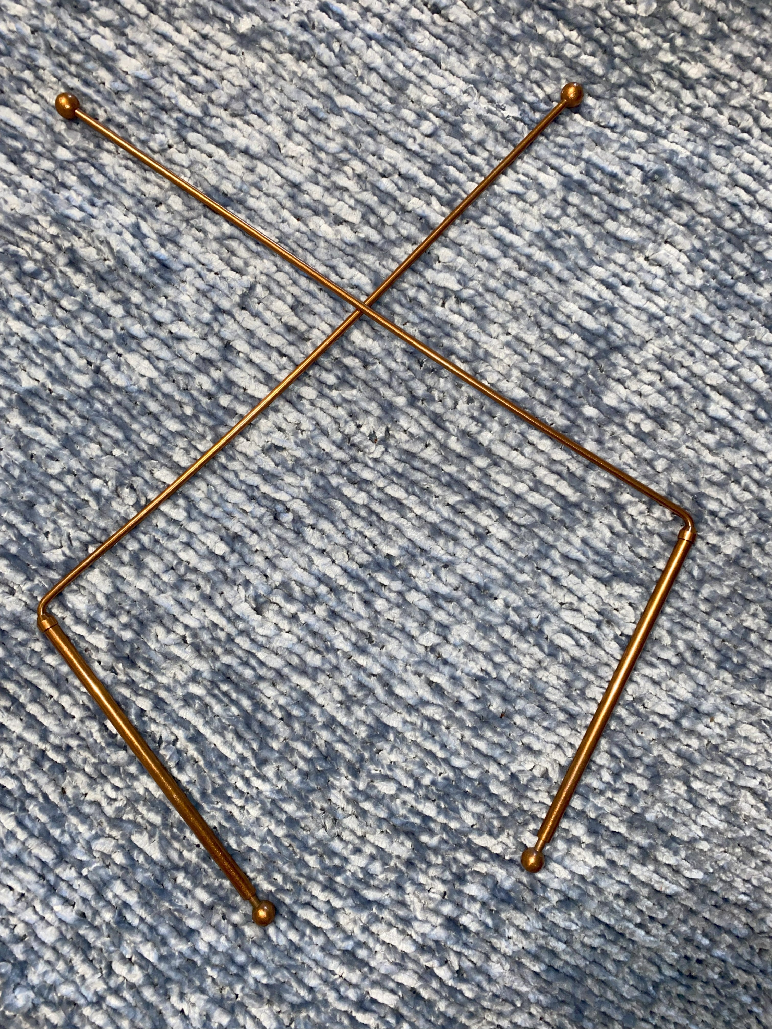 Gold metal copper rods on a textured blue surface