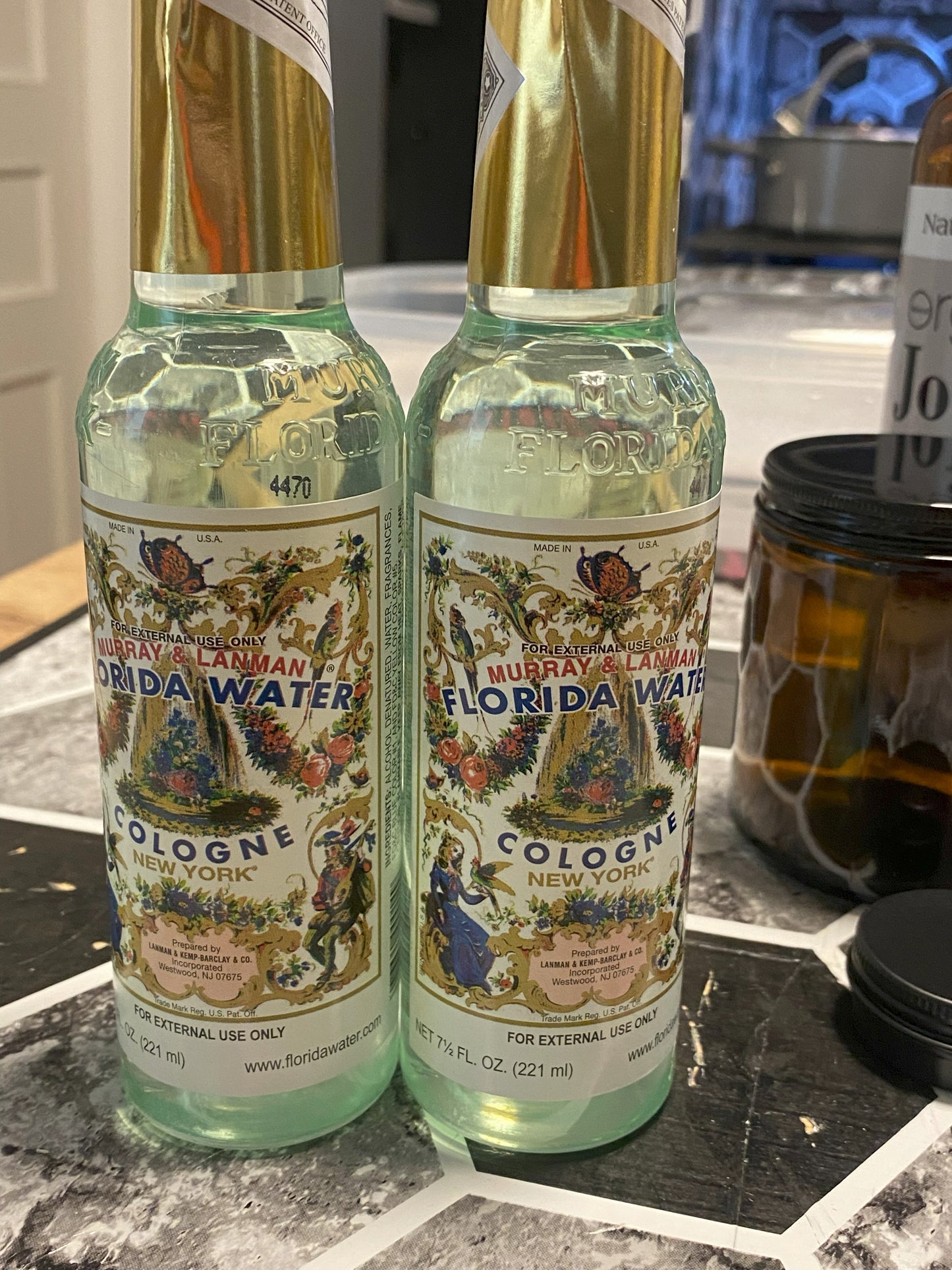 Two bottles of Murray & Lanman Florida Water cologne on a countertop.