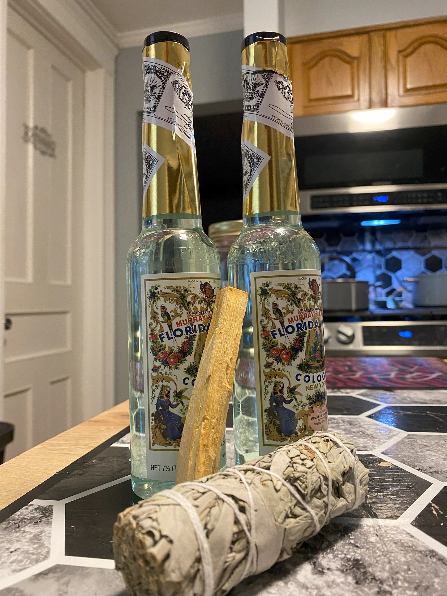 Two bottles of Floridita Cola on a kitchen counter with a smoldering sage bundle.
